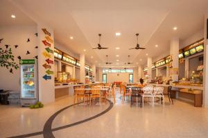 a dining room with tables and chairs in a store at 777 Food & Bed in Chiang Rai