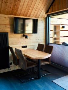 a conference room with a wooden table and chairs at Chalet Muckelstübchen in Bad Arolsen
