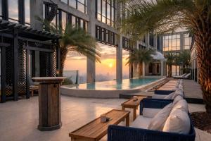a building with a pool in the middle of it at The Orient Jakarta, a Royal Hideaway Hotel in Jakarta
