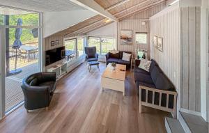 a living room with a couch and a table at Lovely Home In Ebeltoft With Sauna in Ebeltoft