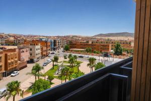 a view of a city from a balcony at Hôtel Aguelmam in Khenifra