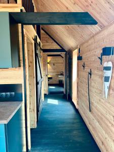 a hallway in a tiny house with wooden walls at Chalet Muckelstübchen in Bad Arolsen