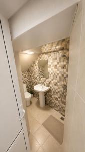 a bathroom with a toilet and a sink at White Hotel in Yerevan