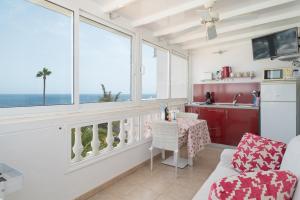 a living room with a view of the ocean at Apartments Gina y Vista Oceano in Puerto del Carmen