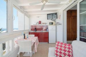 a living room with a table and chairs and a kitchen at Apartments Gina y Vista Oceano in Puerto del Carmen