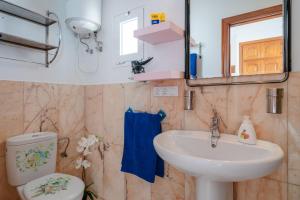 a bathroom with a sink and a toilet and a mirror at Apartments Gina y Vista Oceano in Puerto del Carmen +40 photos