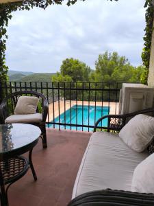 a patio with a bed and chairs and a pool at Pedrera in Banyeres de Mariola