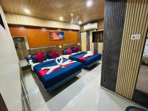 a room with two beds with red pillows at Hotel al raihan in Mumbai