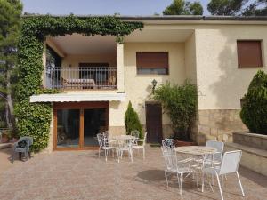 a patio with tables and chairs in front of a house at Pedrera in Banyeres de Mariola