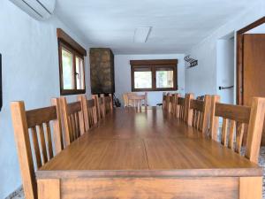 a dining room with a wooden table and chairs at Pedrera in Banyeres de Mariola