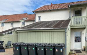 a group of trash cans in front of a house at Nice Apartment In Hanstholm With Wifi in Hanstholm