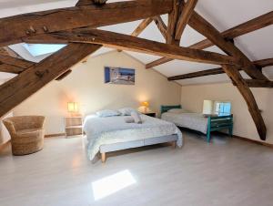 a bedroom with two beds in a attic at Clos de Beauregard in Cirière