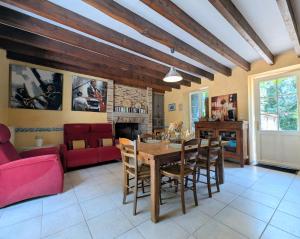 a living room with a wooden table and chairs at Clos de Beauregard in Cirière
