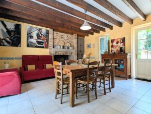 a dining room with a table and chairs and a couch at Clos de Beauregard in Cirière +8 photos