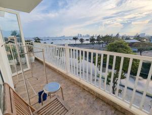 a balcony with a table and a view of the ocean at AN Apartment in Danang
