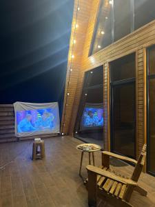 a room with a tv and a bench and a table at Green zone Aframe in Qusar