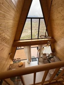 an attic view of a room with a large window at Green zone Aframe in Qusar