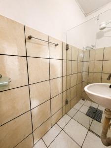 a bathroom with a sink and a shower at Pousada Gire in Itacaré
