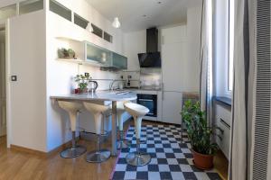 a kitchen with a black and white checkered floor at Nik apartment in Genoa