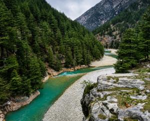 a river in the mountains with green water at Hotel Dharali Nature In Dharali in Gangnāni
