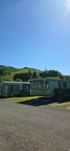 a group of trailers parked in a parking lot at Caravan - Sleeps 8 pet friendly in Welshpool