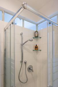 a shower with a glass enclosure in a bathroom at Nik apartment in Genoa +39 photos