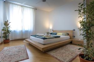a bedroom with a bed and a large window at Nik apartment in Genoa