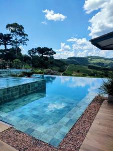 a swimming pool with a view of the hills at Pousada Premium Terragnolo in Bento Gonçalves