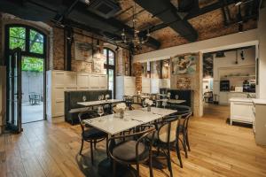 a restaurant with tables and chairs in a room at ARCHE Klasztor Wrocław in Wrocław +66 photos