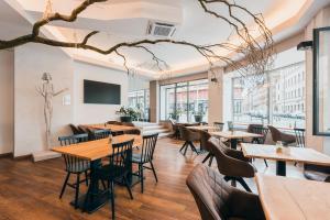 a restaurant with wooden tables and chairs and windows at Belvedere in Prague