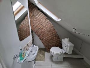 a bathroom with a white toilet and a sink at Castle Room in Windsor