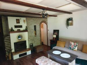 a living room with a couch and a fireplace at Chata Moniela in Drietoma