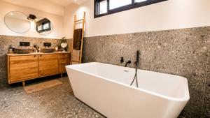 a large white tub in a bathroom with a sink at Le Bosquet-Villa Prestige, Parking privé, Jardin, Wifi in Lys-lès-Lannoy +21 photos