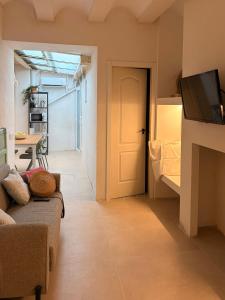 a living room with a couch and a television at Casa Purissima in Ontinyent