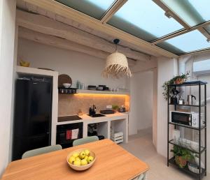 a kitchen with a table with a bowl of fruit on it at Casa Purissima in Ontinyent