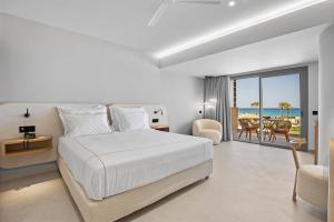 a bedroom with a bed and a view of the ocean at Ventale Island Breeze Resort in Georgioupolis +56 photos