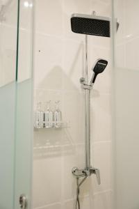 a shower in a bathroom with a glass door at Lumen in Kostanay