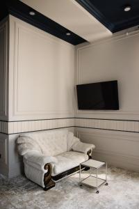 a living room with a couch and a flat screen tv at Lumen in Kostanay +20 photos