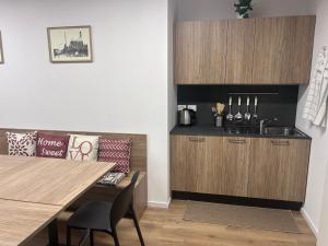 a kitchen with a dining table and a counter at Casa Grevo Bed and Breakfast in Cedegolo