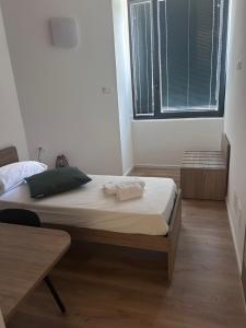 a bedroom with a bed and a large window at Casa Grevo Bed and Breakfast in Cedegolo