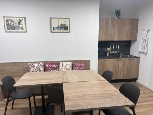 a dining room with two tables and a kitchen at Casa Grevo Bed and Breakfast in Cedegolo +10 photos