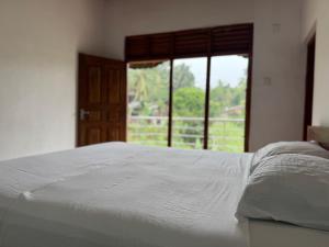 a white bed in a room with a window at Artesa 