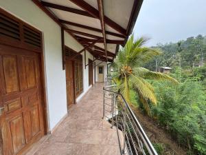 a porch of a house with a door and a palm tree at Artesa 