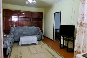 a living room with a couch and a television at BUJAKAN EcoTourism in Buzhakan