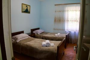 two beds in a room with towels on them at BUJAKAN EcoTourism in Buzhakan