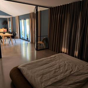 a bedroom with a bed and a table and chairs at Orrvägen in Torshälla
