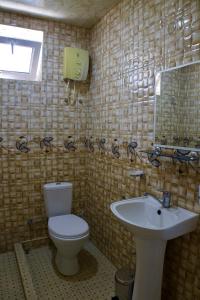 a bathroom with a toilet and a sink at BUJAKAN EcoTourism in Buzhakan +23 photos
