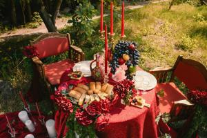 a table with a red table cloth with food on it at BUJAKAN EcoTourism in Buzhakan