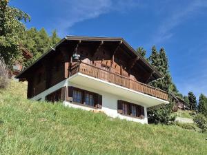 a house with a balcony on the side of a hill at Chalet Bisse Neuf in Saint-Luc