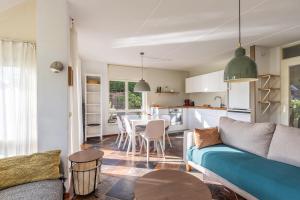 a living room with a couch and a table at Cozy Waterfront Getaway for a Perfect Holiday in Langweer